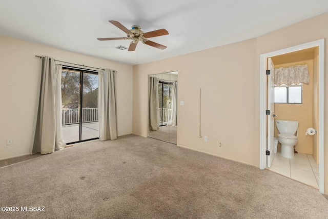 unfurnished room with a wealth of natural light, light colored carpet, and ceiling fan