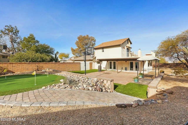 back of property with a patio