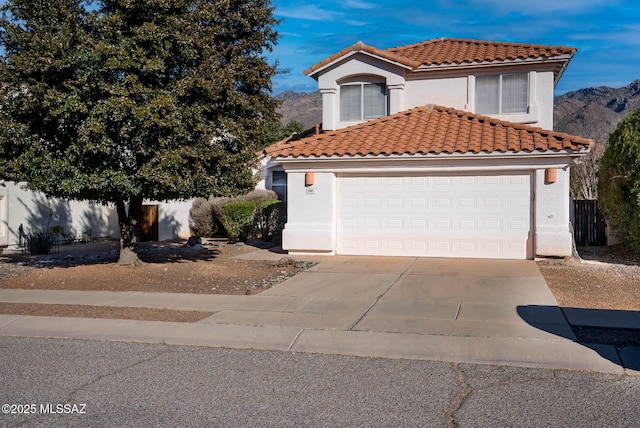 view of front of property featuring a mountain view and a garage