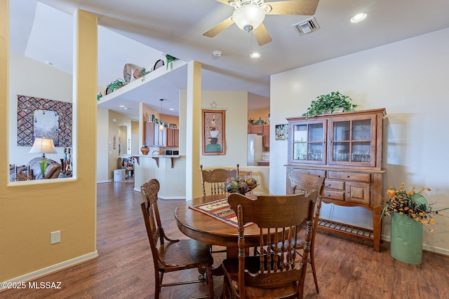 dining room with ceiling fan and dark hardwood / wood-style floors