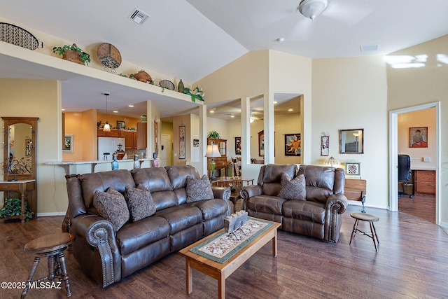 living room featuring ceiling fan, dark hardwood / wood-style flooring, and high vaulted ceiling