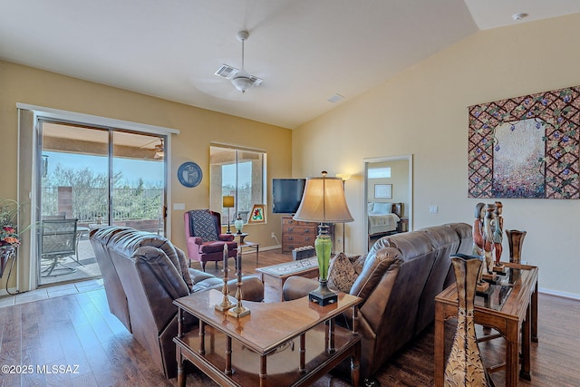 living room with vaulted ceiling and hardwood / wood-style floors