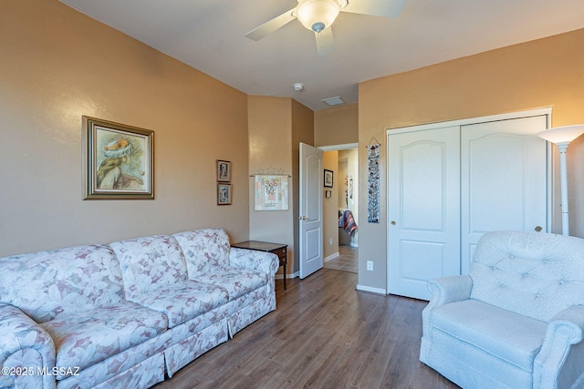 living room featuring dark hardwood / wood-style flooring and ceiling fan