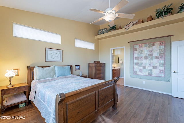 bedroom with ceiling fan, connected bathroom, and dark hardwood / wood-style flooring