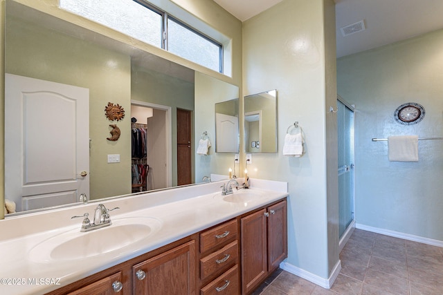 bathroom with vanity, tile patterned flooring, and a shower with shower door