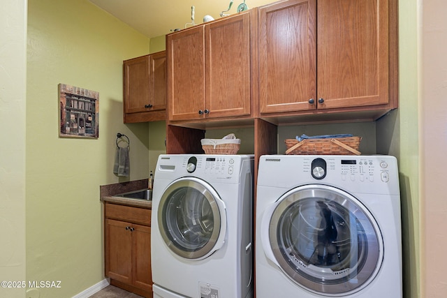 laundry room featuring cabinets and washing machine and dryer