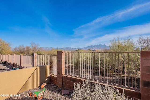 view of gate with a mountain view