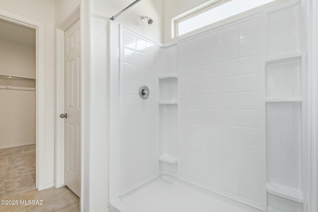 bathroom with tile patterned floors and walk in shower