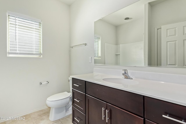 bathroom featuring tile patterned floors, toilet, vanity, and a shower