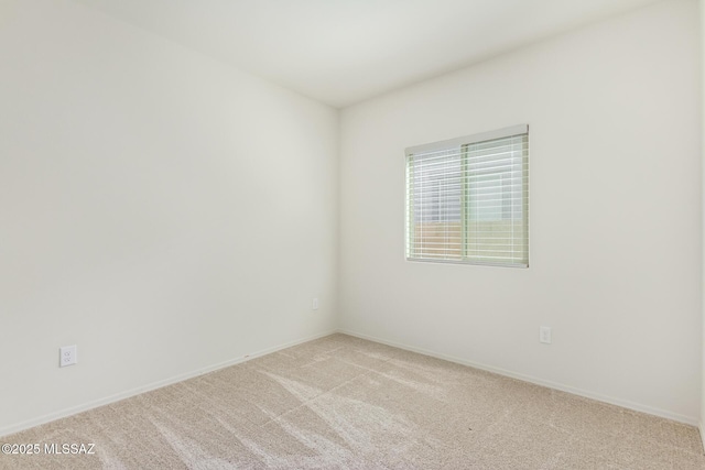 unfurnished room with light colored carpet