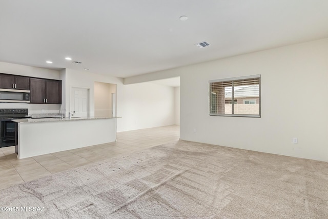 unfurnished living room featuring light carpet