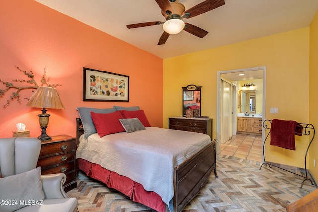 bedroom featuring ceiling fan, ensuite bath, and sink