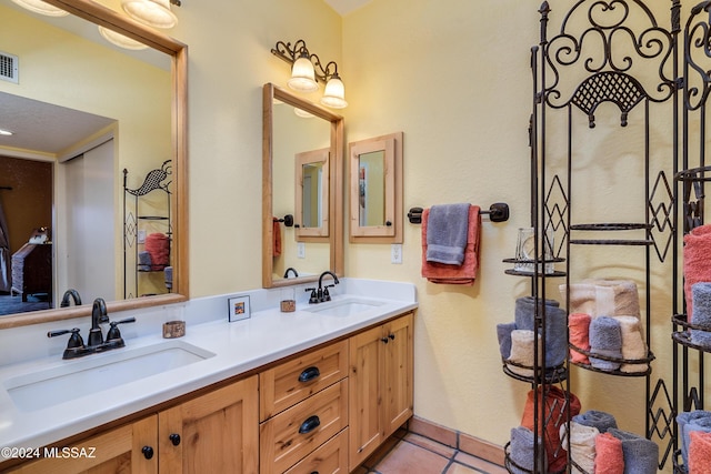 bathroom with tile patterned flooring and vanity