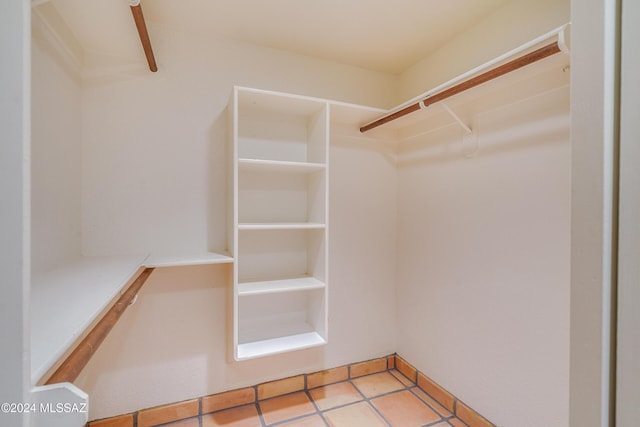 spacious closet with light tile patterned floors