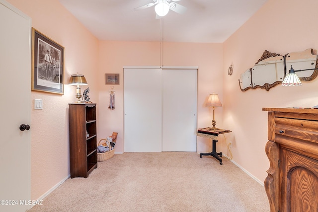 interior space featuring ceiling fan and carpet