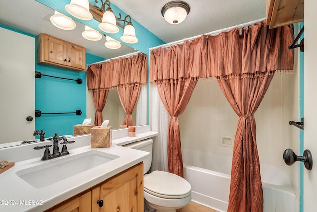 full bathroom featuring vanity, shower / bath combination with curtain, and toilet