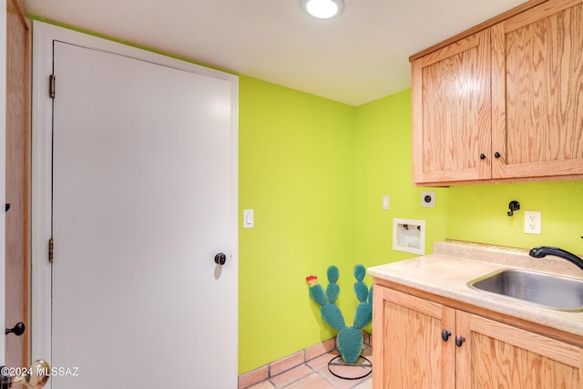 clothes washing area featuring sink, cabinets, light tile patterned floors, electric dryer hookup, and washer hookup