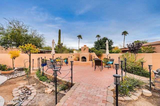 view of patio / terrace with exterior fireplace