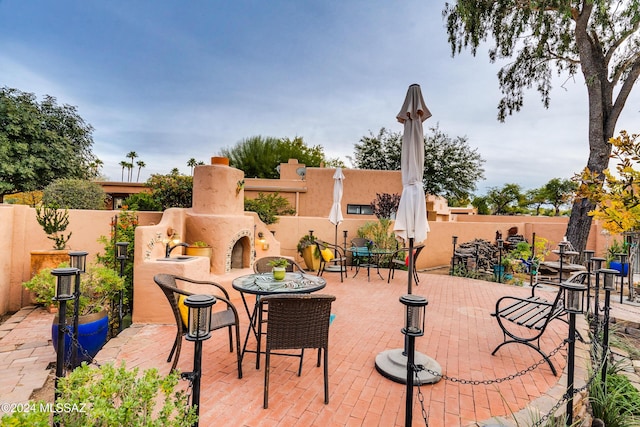 view of patio / terrace with exterior fireplace