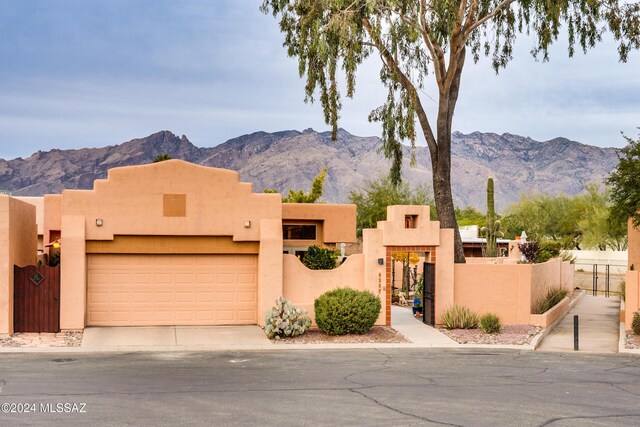 adobe home featuring a mountain view and a garage