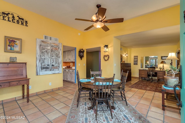 tiled dining space with lofted ceiling and ceiling fan