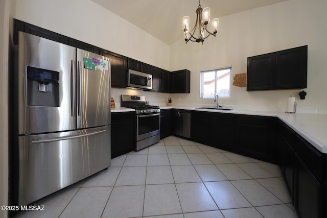 kitchen featuring appliances with stainless steel finishes, a chandelier, light tile patterned floors, sink, and pendant lighting