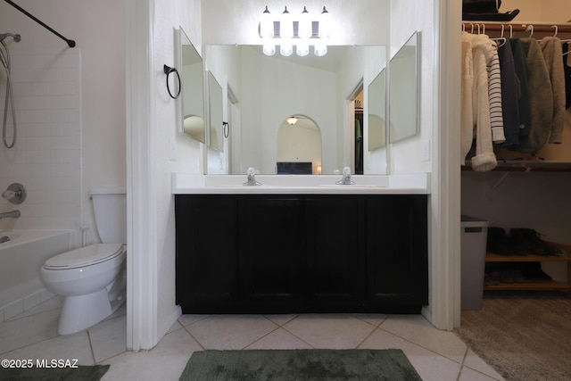 full bathroom featuring vanity, toilet, tile patterned floors, and tiled shower / bath combo