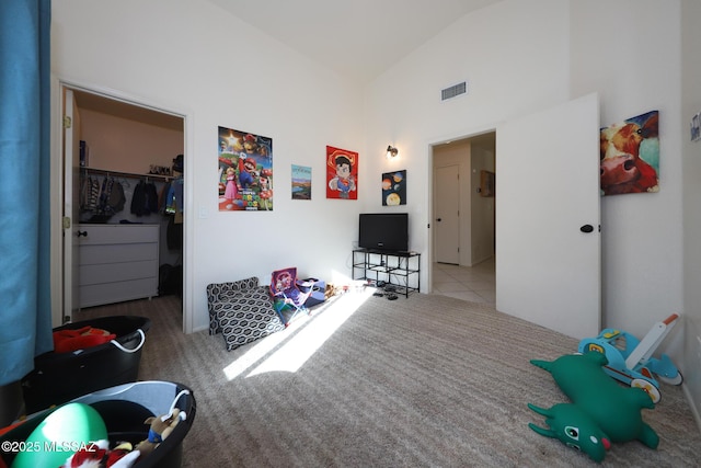 interior space with light carpet and vaulted ceiling