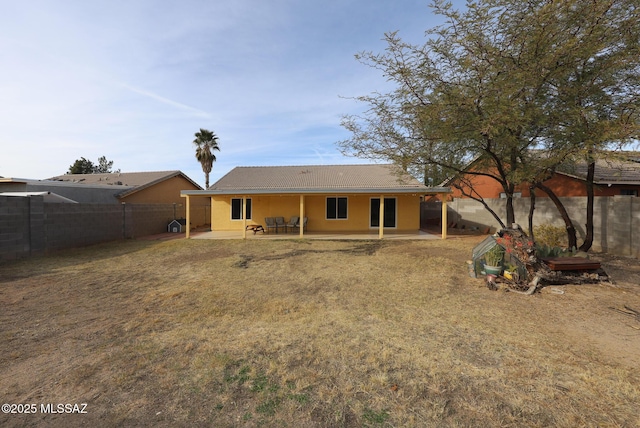 back of property featuring a patio