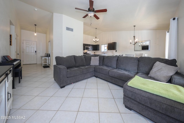 tiled living room with ceiling fan with notable chandelier and lofted ceiling