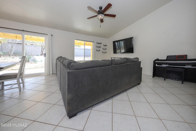 living room with ceiling fan, light tile patterned floors, and lofted ceiling