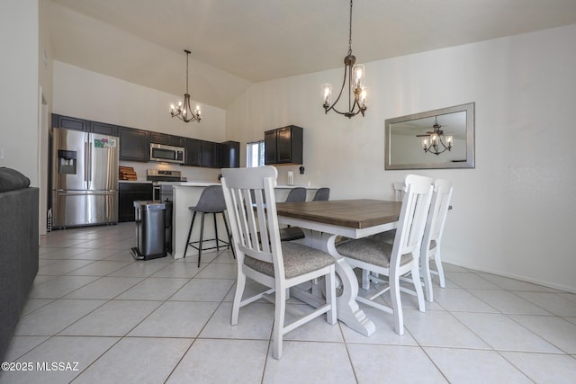 tiled dining space featuring lofted ceiling and a chandelier