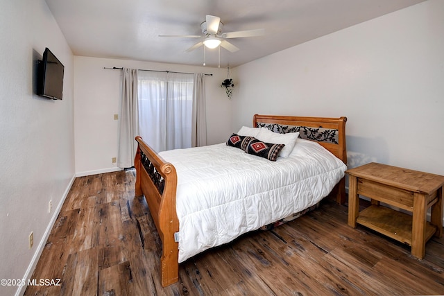 bedroom with dark hardwood / wood-style floors and ceiling fan