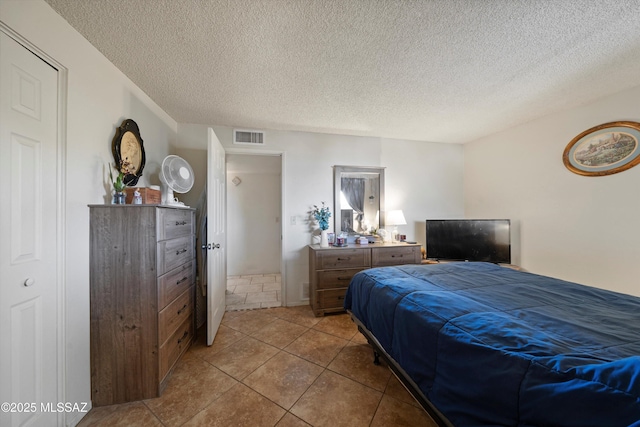 tiled bedroom with a textured ceiling