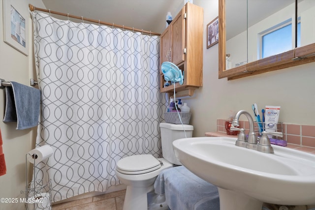 bathroom with sink, a shower with shower curtain, tile patterned floors, and toilet