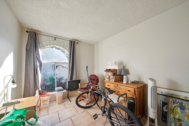 miscellaneous room featuring light tile patterned floors and a textured ceiling