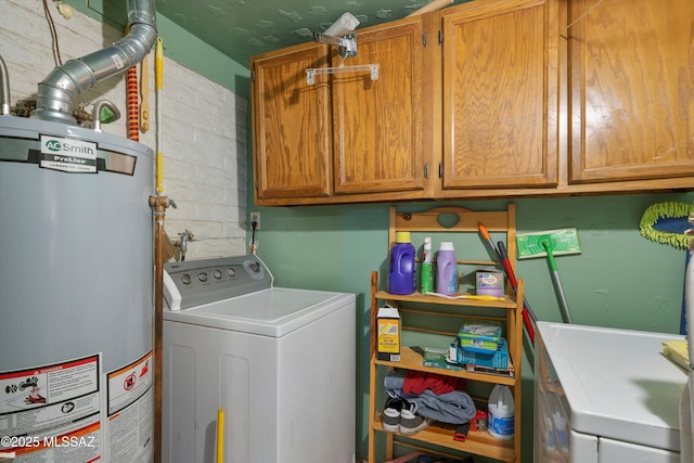 laundry room featuring washer / clothes dryer, gas water heater, and cabinets