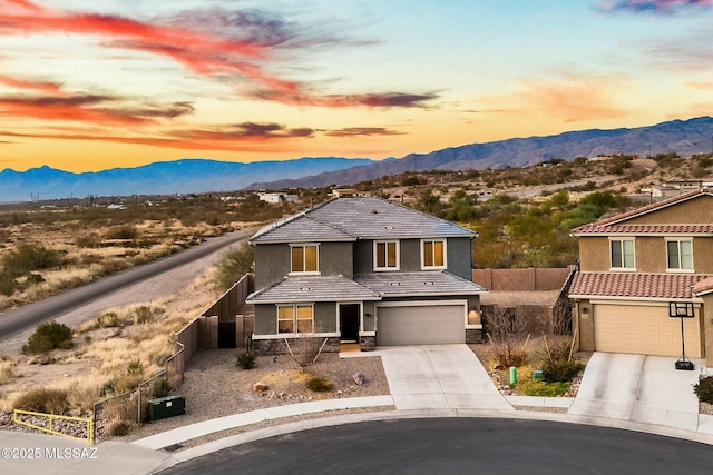 view of front of property featuring a mountain view and a garage