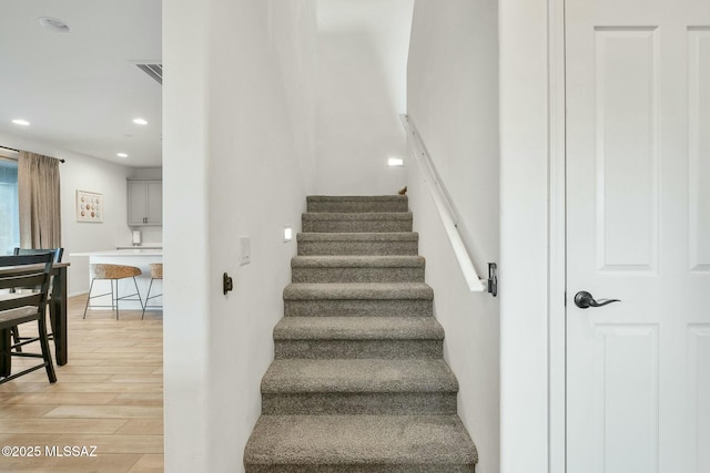 stairs featuring hardwood / wood-style flooring