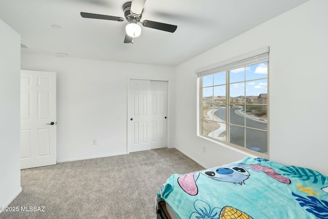 unfurnished bedroom featuring a closet, ceiling fan, and carpet