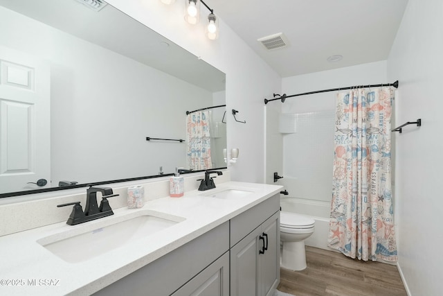 full bathroom with vanity, toilet, shower / bath combo, and wood-type flooring