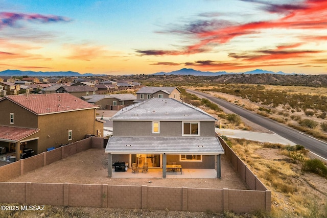 exterior space with a mountain view and a patio