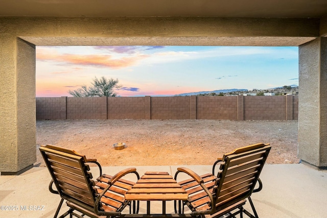 view of patio terrace at dusk