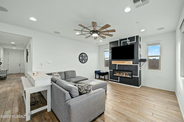 living room featuring hardwood / wood-style flooring and ceiling fan