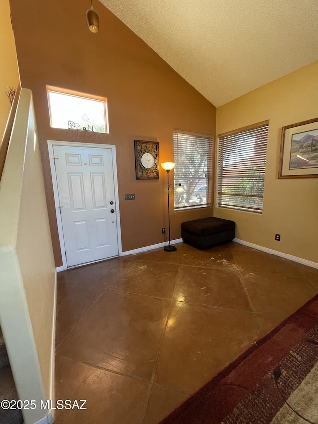 tiled foyer with high vaulted ceiling