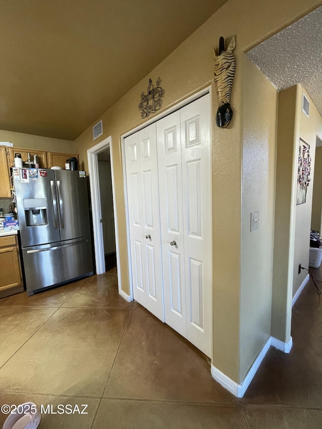 kitchen featuring stainless steel refrigerator with ice dispenser