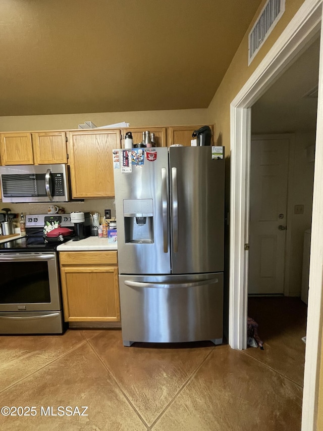 kitchen with light brown cabinets and stainless steel appliances