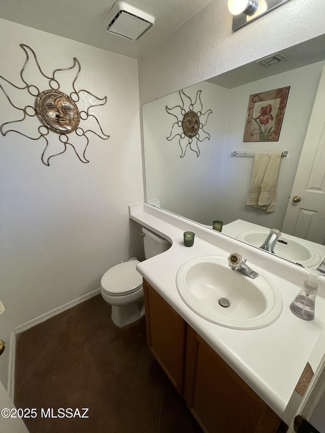 bathroom featuring toilet and vanity