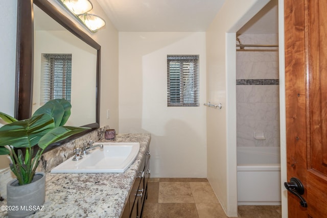 full bathroom with  shower combination, baseboards, and vanity