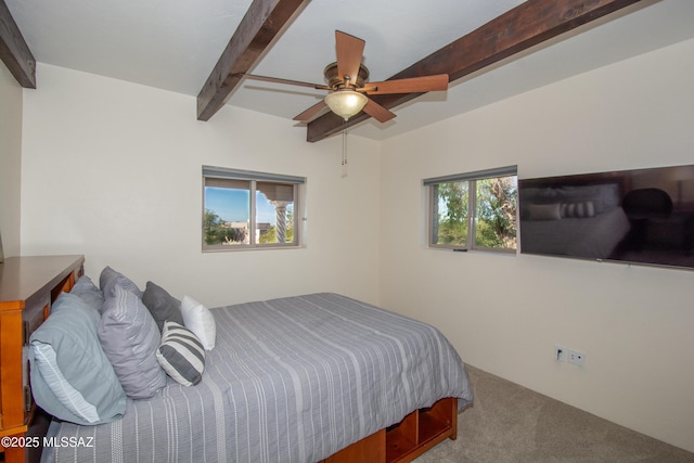 bedroom featuring beamed ceiling, carpet, and a ceiling fan